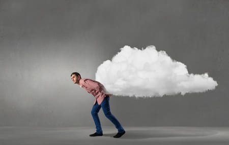 stooped over man carrying a cloud on his back