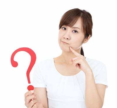girl holding question mark